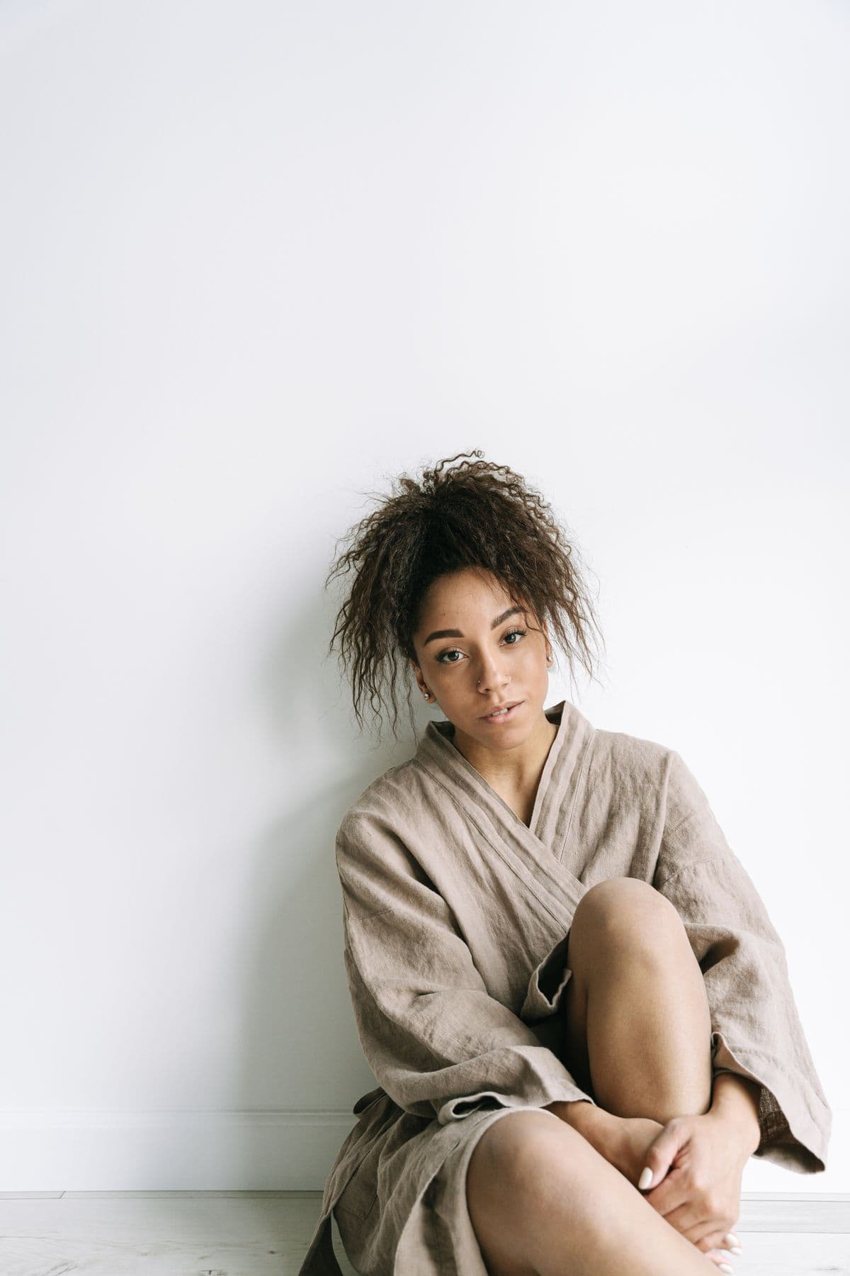 A young woman sitting quietly in soft morning light